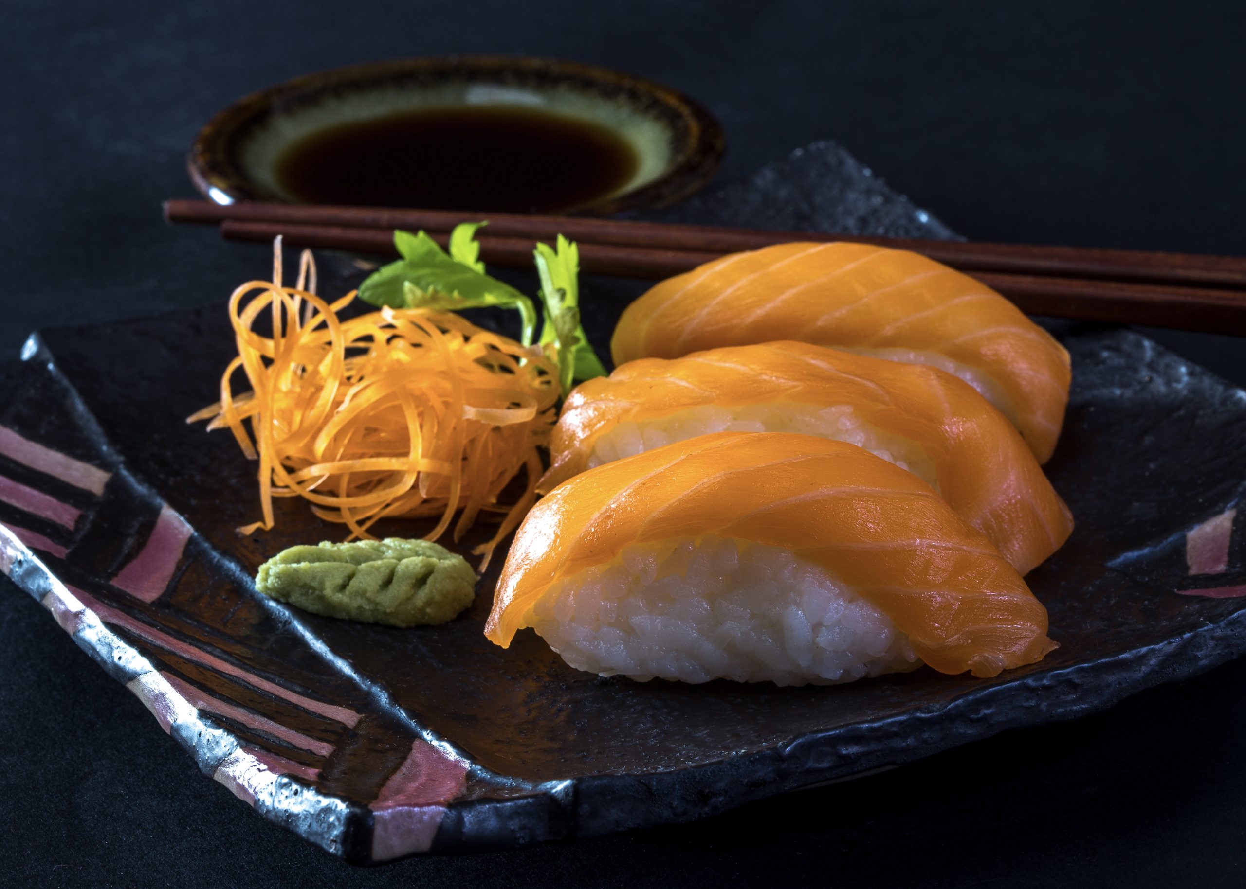 Close-up shot sushi isolated on black background